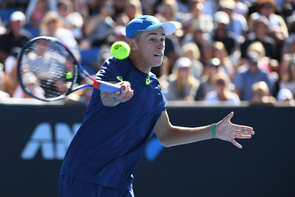 Australia's Alex de Minaur hits a return against Sam Querrey of the US during their men's singles match on day three of the Australian Open tennis tournament in Melbourne on January 18, 2017.