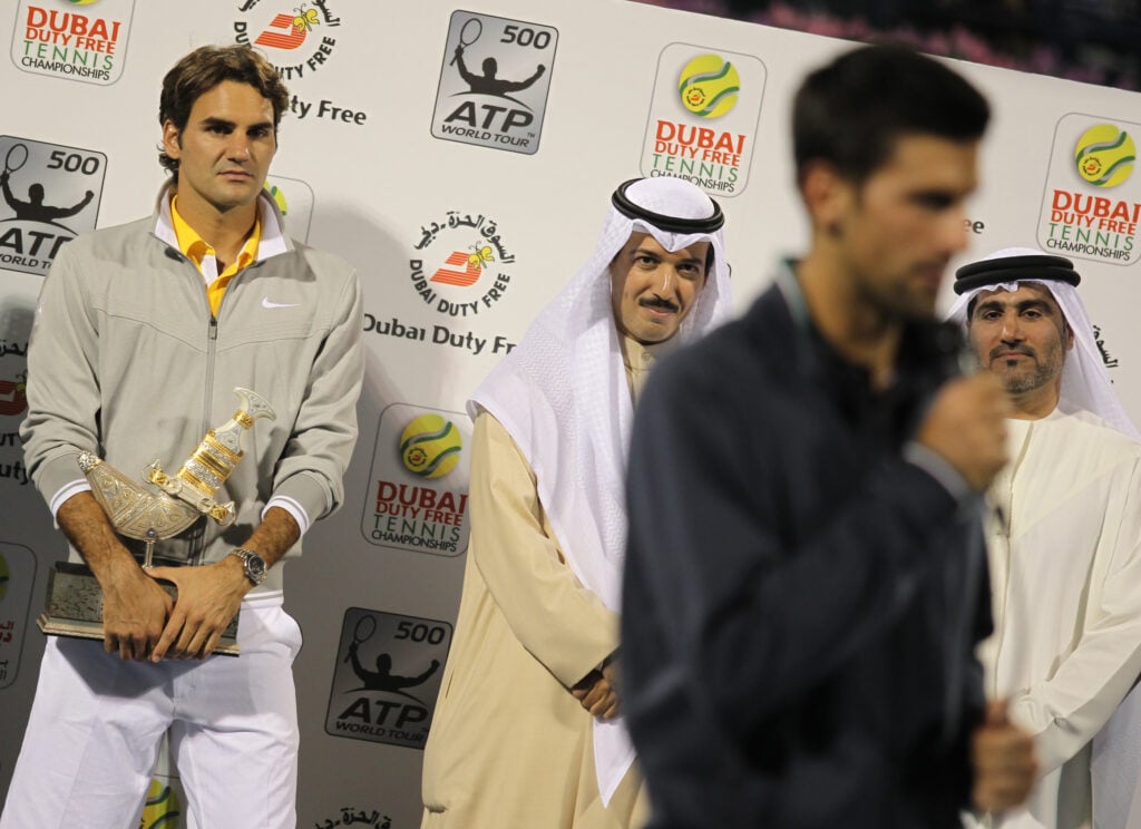 Swiss Roger Federer (L) listens to the speech of Serbia's Novak Djokovic after their Dubai ATP Open final Tennis match on February 26, 2011 in Dubai. Djokovic won 6-3, 6-3.