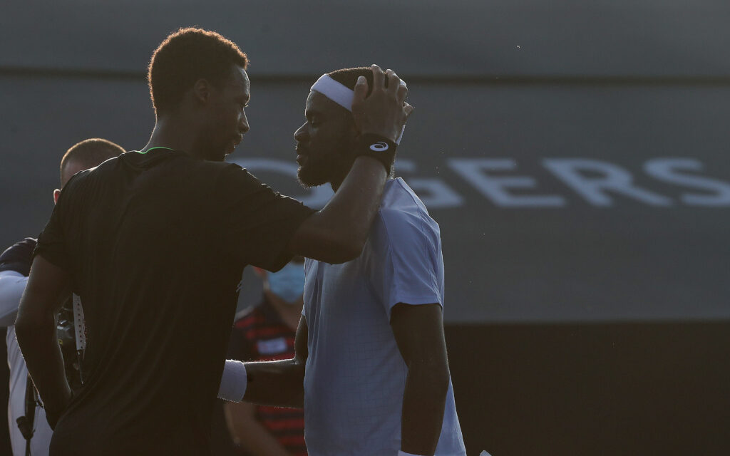 Gael Monfils meets Frances Tiafoe at the net
