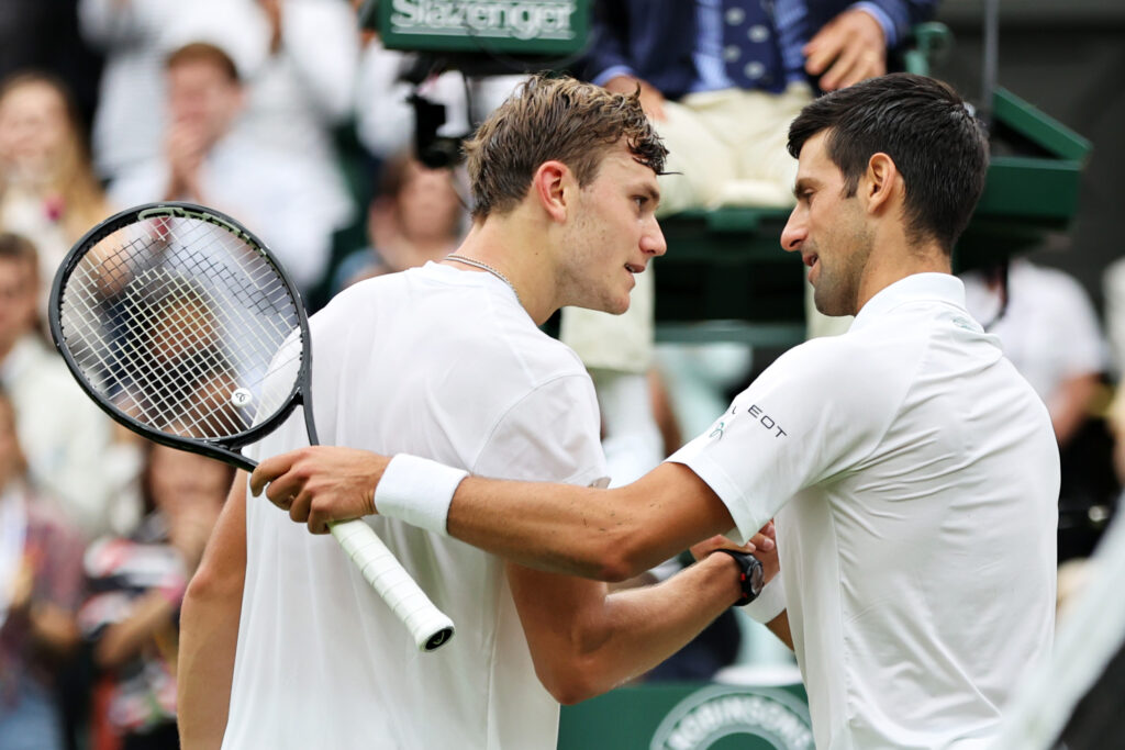 Jack Draper and Novak Djokovic shake hands after their match at Wimbledon