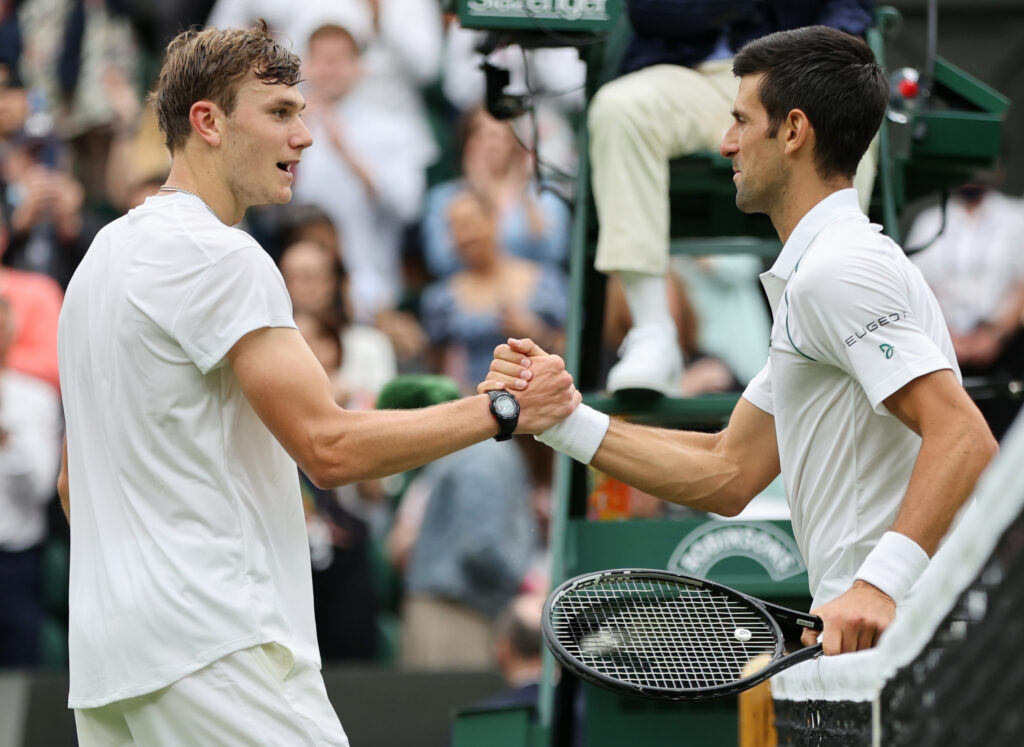 Novak Djokovic of Serbia and Jack Draper of Great Britain shake hands at the net after their Men's Singles First Round match during Day One of The Championships - Wimbledon 2021 at All England Lawn Tennis and Croquet Club on June 28, 2021 in London, England.