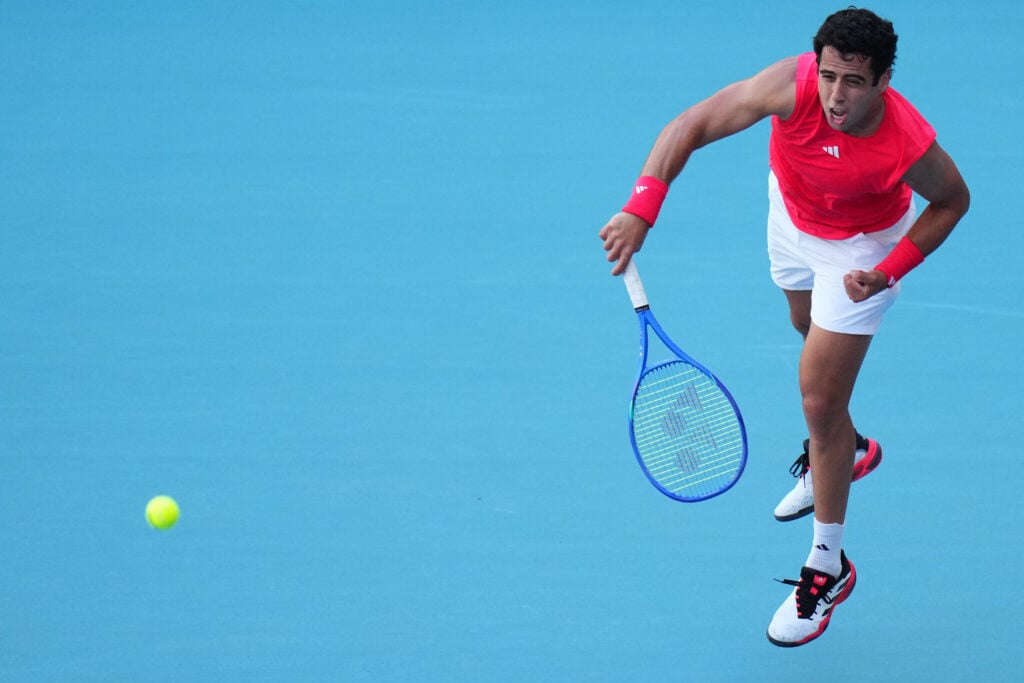Jaume Munar of Spain returns a shot against Daniil Medvedev during their match on Day 4 at Hard Rock Stadium on March 21, 2025 in Miami Gardens, Florida.