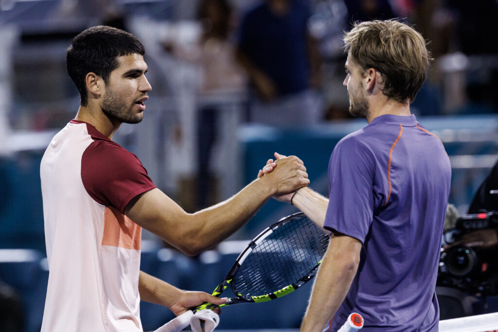David Goffin of Belgium shakes hands with Carlos Alcaraz of Spain after beating him in the second round of the men's singles in the Miami Open at the Hard Rock Stadium on March 21, 2025 in Miami Gardens, Florida.