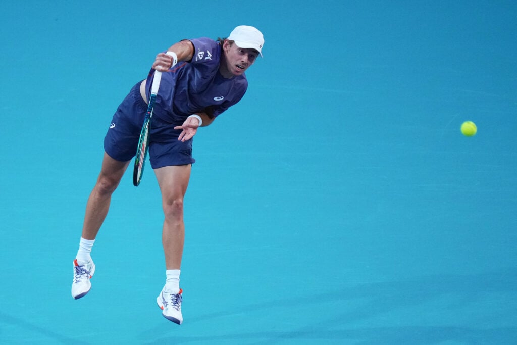 Alex de Minaur of Australia serves against Joao Fonseca of Brazil during their match on day 7 of the Miami Open at Hard Rock Stadium on March 24, 2025 in Miami Gardens, Florida.
