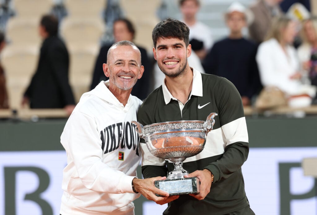 Carlos Alcaraz of Spain poses for a photo with his coach Samuel Lopez following his victory over Jannik Sinner of Italy in the Men's Singles Final on Day Fifteen of the 2025 French Open at Roland Garros on June 08, 2025 in Paris, France.