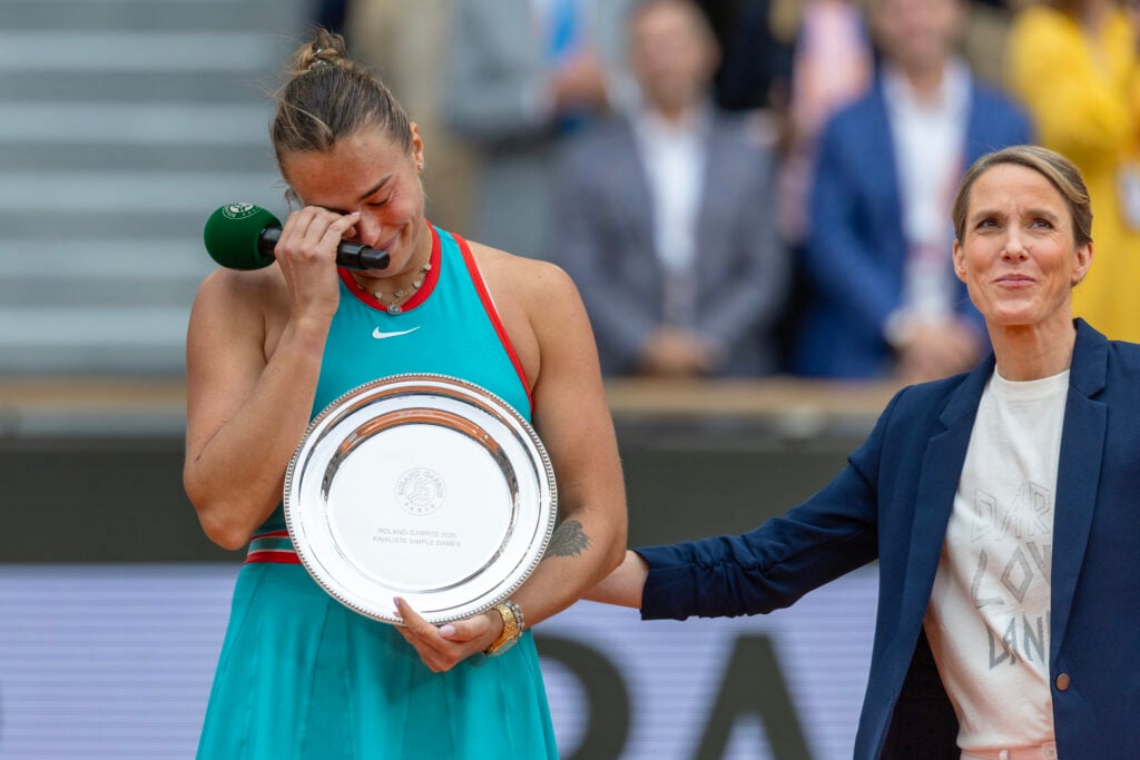 Runner-up Aryna Sabalenka is consoled by former French Open champion Justine Henin at the trophy presentation after the Women's Singles Final on Court Philippe-Chatrier during the 2025 French Open Tennis Tournament at Roland Garros on June 7th, 2025, in Paris, France.
