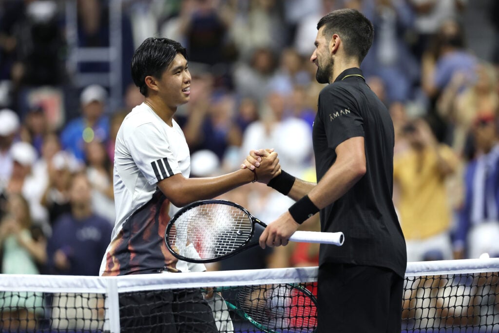 Novak Djokovic of Serbia (R) greets Learner Tien of the United States following their Men's Singles First Round match on Day One of the 2025 US Open at USTA Billie Jean King National Tennis Center on August 24, 2025 in the Flushing neighborhood of the Queens borough of New York City.