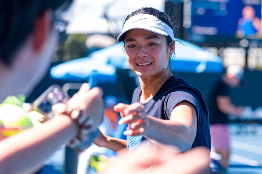 Alexandra Eala of Philippines signs autographs for fans during a practice session ahead of the 2026 Australian Open at Melbourne Park on January 17, 2026 in Melbourne, Australia.