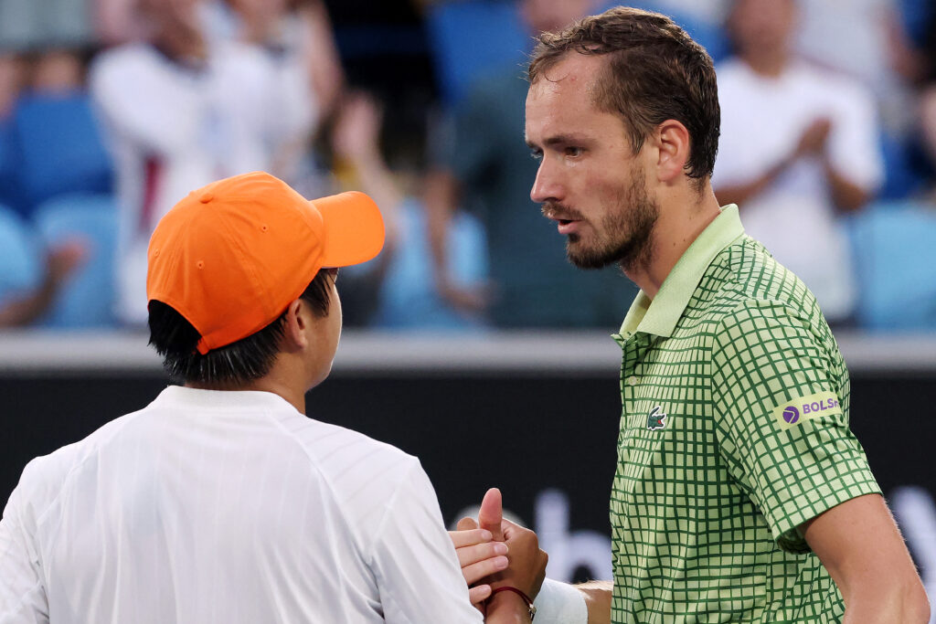 USA's Learner Tien (L) shakes hands with Russia's Daniil Medvedev after their men's singles match on day eight of the Australian Open tennis tournament in Melbourne on January 25, 2026.