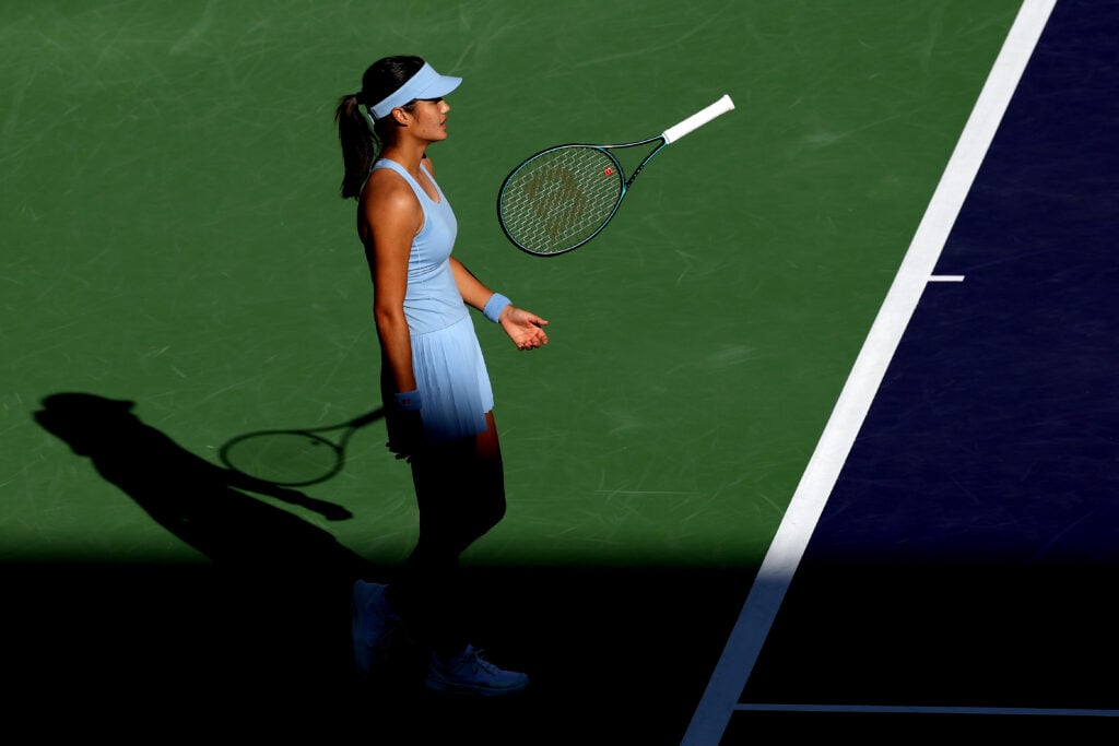Emma Raducanu tosses her racket