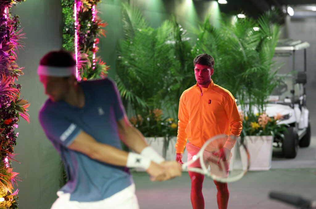 Carlos Alcaraz of Spain and Arthur Rinderknech of France (foreground) warm up in the players tunnel before their third round match of the BNP Paribas Open at Indian Wells Tennis Garden on March 09, 2026 in Indian Wells, California.