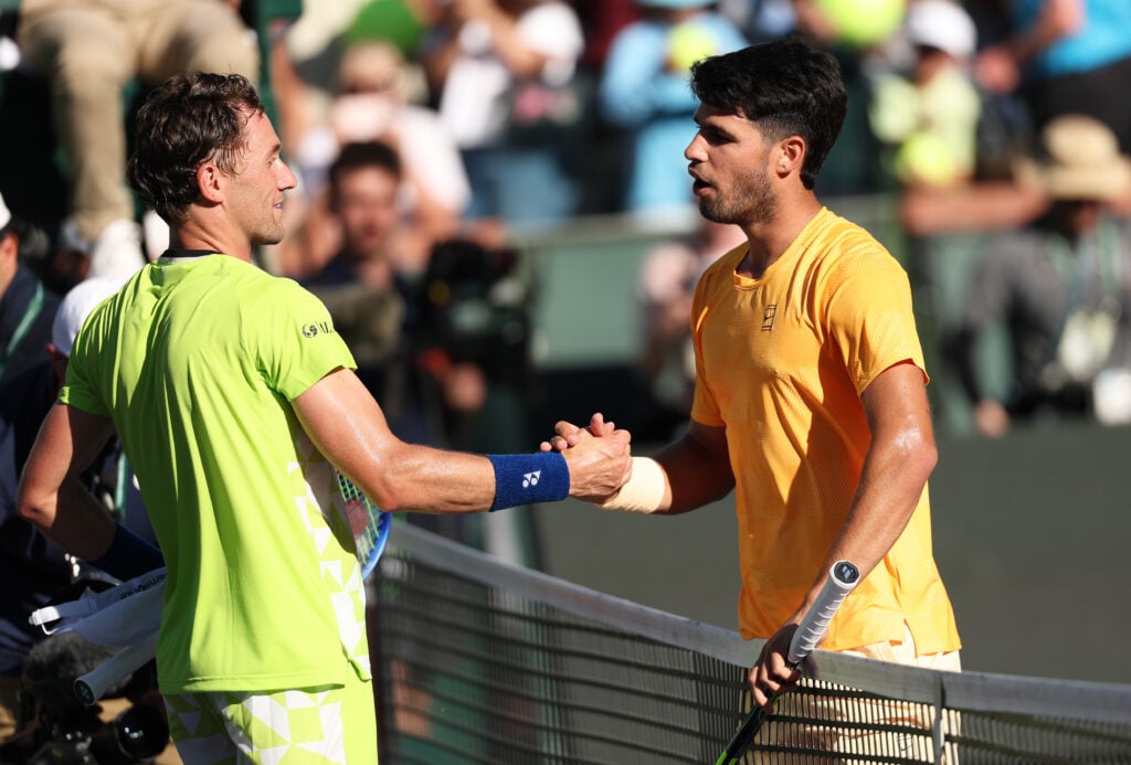 Carlos Alcaraz of Spain shakes hands at the net after his straight sets victory against Casper Ruud of Norway in their fourth round match of the BNP Paribas Open at Indian Wells Tennis Garden on March 11, 2026 in Indian Wells, California.