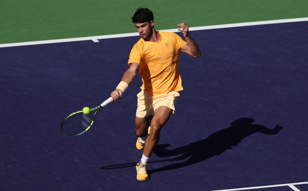 Carlos Alcaraz of Spain plays a forehand against Casper Ruud of Norway in their fourth round match of the BNP Paribas Open at Indian Wells Tennis Garden on March 11, 2026 in Indian Wells, California.