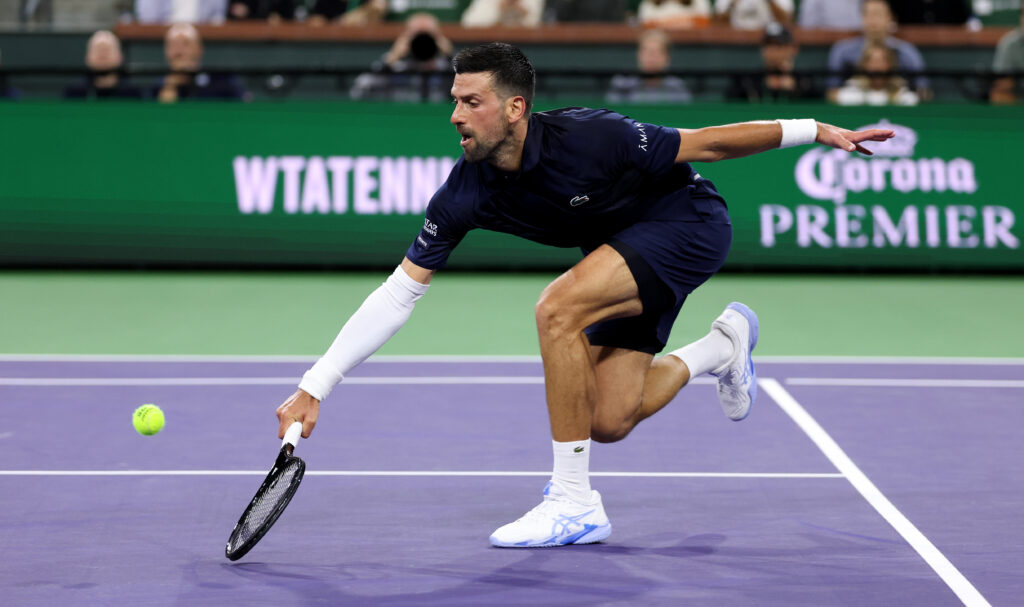 Novak Djokovic of Serbia plays a backhand volley against Jack Draper of Great Britain in their fourth round match of the BNP Paribas Open at Indian Wells Tennis Garden on March 11, 2026 in Indian Wells, California.