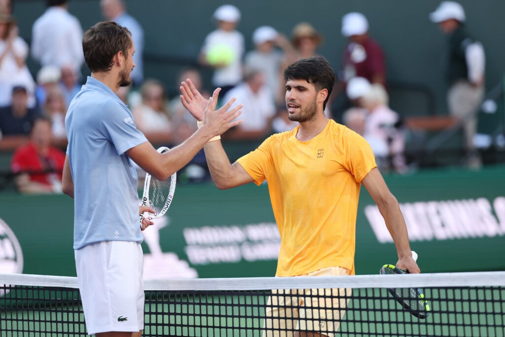 Carlos Alcaraz of Spain, right, shakes hands with Daniil Medvedev after being defeated during their Men's Singles Semifinals match on Day 11 of the BNP Paribas Open at Indian Wells Tennis Garden on March 14, 2026 in Indian Wells, California.