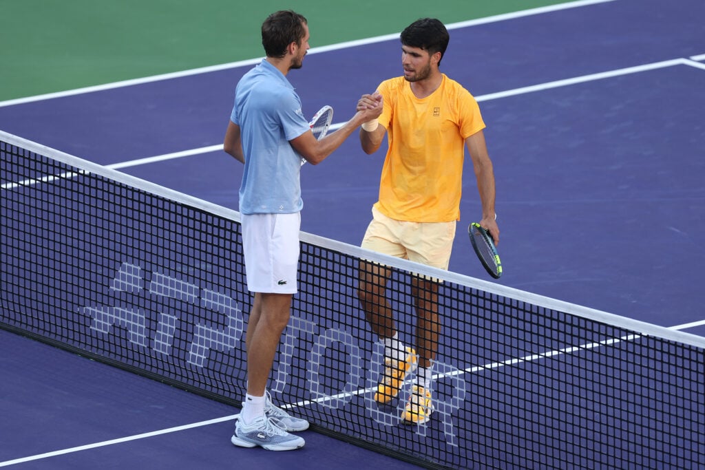 Carlos Alcaraz of Spain, right, shakes hands with Daniil Medvedev after being defeated during their Men's Singles Semifinals match on Day 11 of the BNP Paribas Open at Indian Wells Tennis Garden on March 14, 2026 in Indian Wells, California.