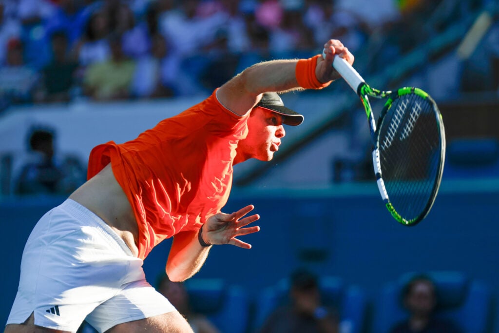 Alex Michelsen serves against Jannik Sinner at the 2026 Miami Open