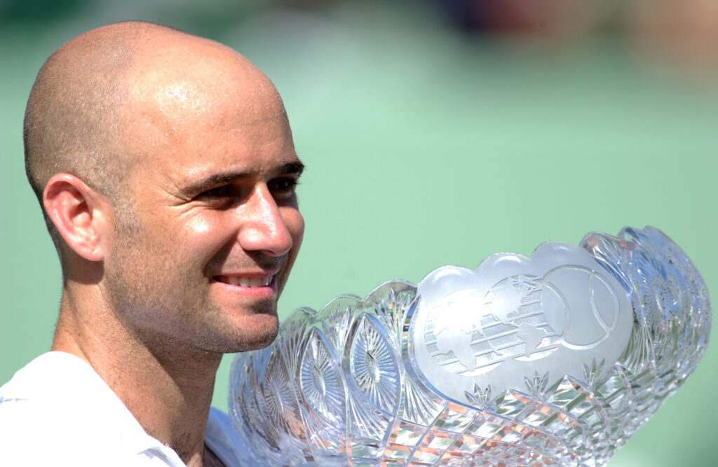 Andre Agassi of the USA holds aloft the trophy after winning the Nasdaq 100 Open Final held at the Tennis Center at Crandon Park, in Miami, Florida.
