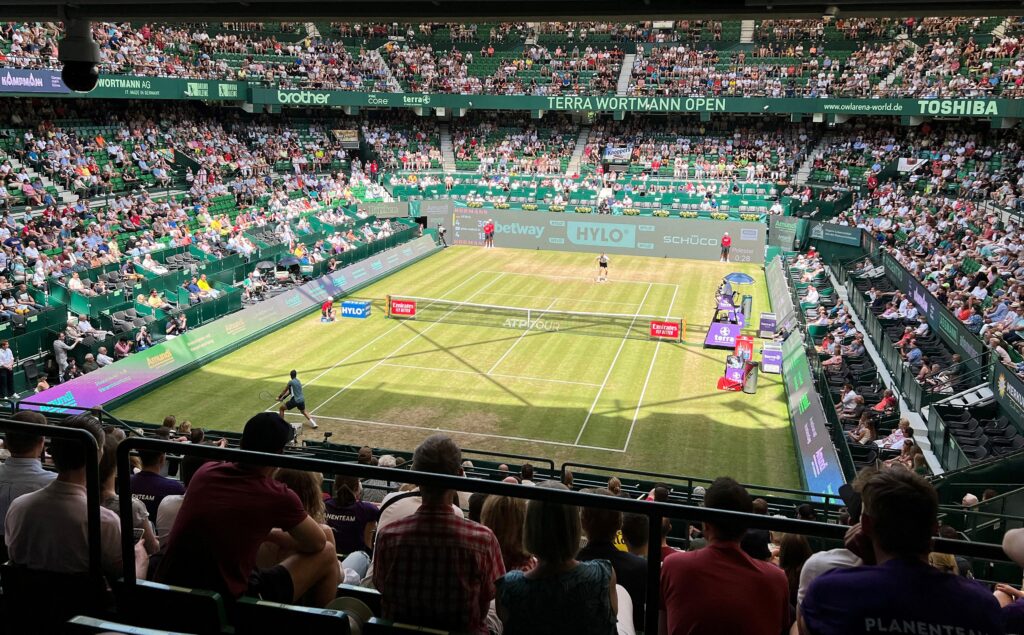 The Centre Court in the OWL Arena (formerly known as Gerry Weber Stadion), an outdoor grass court with a retractable roof, is pictured while spectators attend the ATP tennis tournament at the ATP 500 Halle Open tennis tournament in Halle, western Germany, on June 17, 2022.