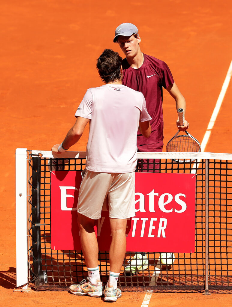 Guido Pella of Argentina shakes hands with opponent Jannik Sinner of Italy following defeat in his men's singles match during day six of the Mutua Madrid Open at La Caja Magica on May 04, 2021 in Madrid, Spain.