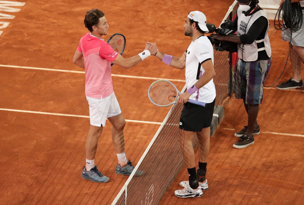 Casper Ruud of Norway shakes hands with Matteo Berrettini (R) of Italy following the Men's Singles Semi-Final match between Casper Ruud of Norway and Matteo Berrettini of Italy on Day Ten of the Mutua Madrid Open at La Caja Magica on May 08, 2021 in Madrid, Spain.