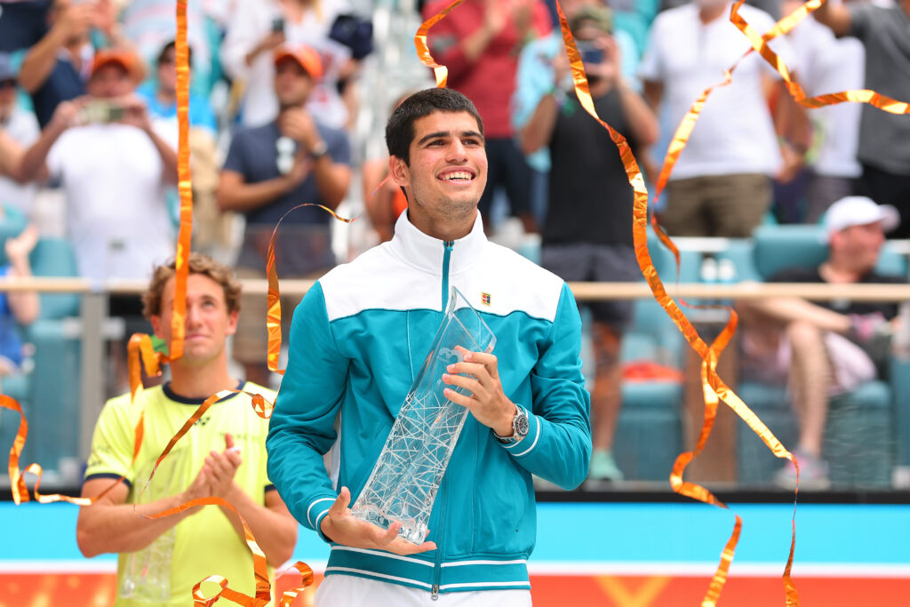 Carlos Alcaraz of Spain raises the Butch Buchholz Trophy after defeating Casper Ruud of Norway in the Men's Singles final during the Miami Open at Hard Rock Stadium on April 03, 2022 in Miami Gardens, Florida.