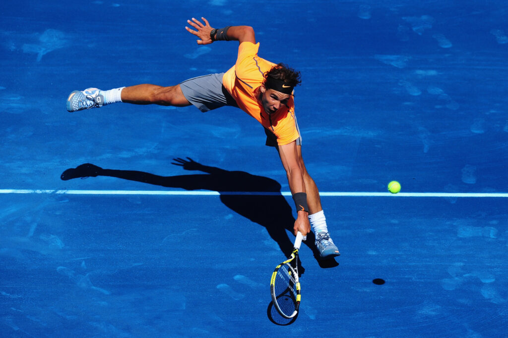 Rafael Nadal of Spain plays a backhand during his 3rd round match against Nikolay Davydenko of Russia during the Mutua Madrilena Madrid Open at the Caja Magica on May 9, 2012 in Madrid, Spain.