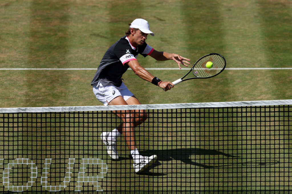 Alex De Minaur of Australia plays a backhand against Carlos Alcaraz of Spain during the Men's Singles Final match on Day Seven of the cinch Championships at The Queen's Club on June 25, 2023 in London, England.