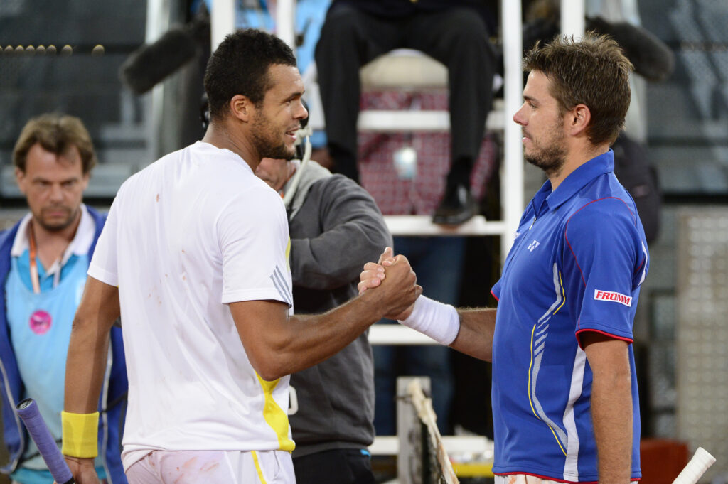 French player Jo-Wilfried Tsonga (L) shakes hands with Swiss player Stanislas Wawrinka at the end of his tennis match at the Madrid Masters at the Caja Magica (Magic Box) sports complex in Madrid on May 10, 2013. Wawrinka won 6-2, 6-7, 6-4.