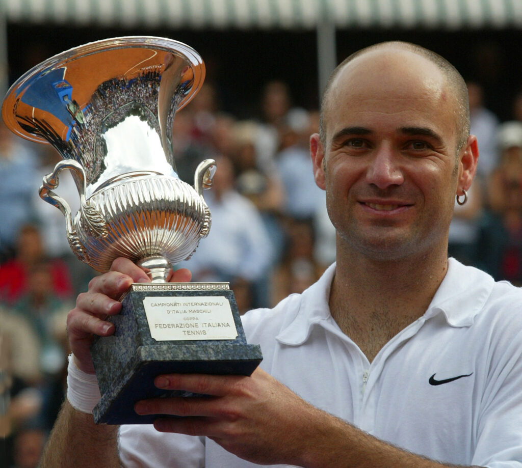 US Andre Agassi holds up the winner's trophy after his victory against German Tommy Haas in the final match of Rome's 3 million Euros (2.8 million $) Masters Series tournament at the Foro Italico Stadium, 12 May 2002. Agassi won 6-3, 6-3, 6-0.