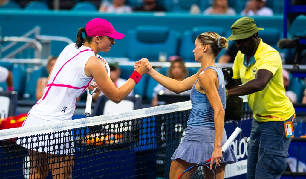 Iga Swiatek of Poland and Camila Giorgi of Italy shake hands at the net after the second round on Day 8 of the Miami Open Presented by Itau at Hard Rock Stadium on March 23, 2024 in Miami Gardens, Florida
