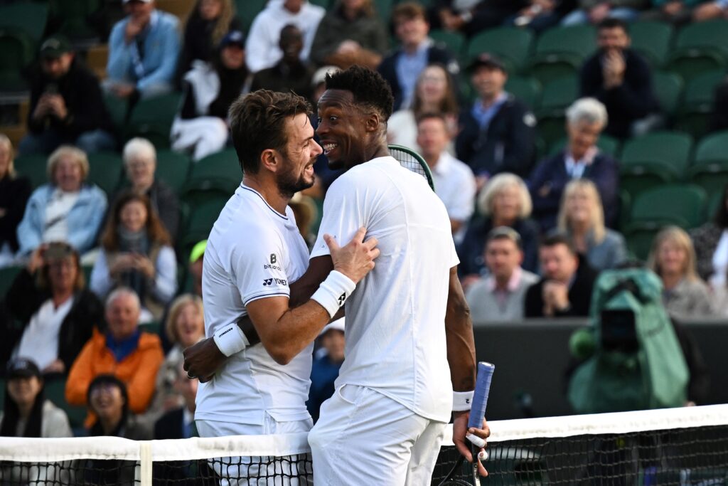 France's Gael Monfils (R) laughs with Switzerland's Stan Wawrinka (L) during their men's singles second round tennis match on the third day of the 2024 Wimbledon Championships at The All England Lawn Tennis and Croquet Club in Wimbledon, southwest London, on July 3, 2024.