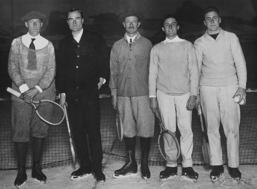 American tennis player Theodore Pell, American tennis player Watson Washburn, American tennis player Fred Alexander, American tennis player Dean Mathey, and American tennis player Francis Hunter, each holding a tennis racquet and wearing ice skates during an 'ice tennis' match in New York City, New York, December 1916.