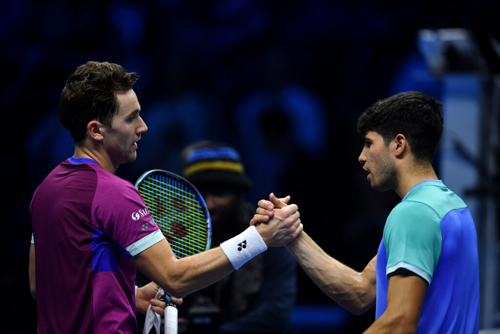 Casper Ruud (L) of Norway celebrates a winning match point against Carlos Alcaraz of Spain as they shake hands after playing on day two of the Nitto ATP finals 2024 at Inalpi Arena on November 11, 2024 in Turin, Italy.