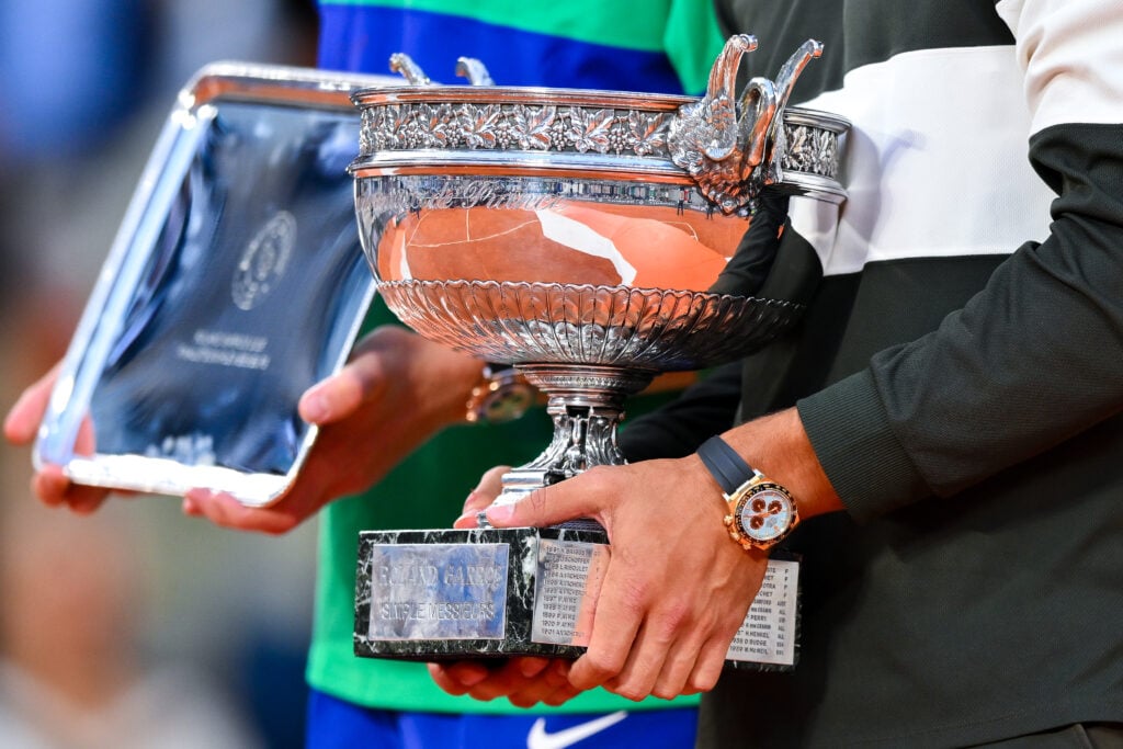 Carlos Alcaraz and Jannik Sinner pose with their trophies after the 2025 French Open final