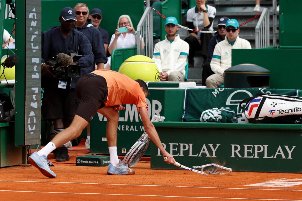 Russia's Daniil Medvedev smashes his racket on the clay as he plays against Italy's Matteo Berrettini during the Monte Carlo ATP Masters Series Tournament round of 32 tennis match on Court Rainier III at the Monte-Carlo Country Club in Roquebrune-Cap-Martin, south-eastern France on April 8, 2026.