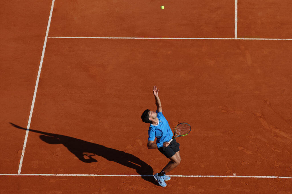Spain's Carlos Alcaraz eyes the ball to serve to Argentina's Tomas Martin Etcheverry during their Monte Carlo ATP Masters Series Tournament round of 16 tennis match on Court Rainier III at the Monte-Carlo Country Club in Roquebrune-Cap-Martin, south-eastern France on April 9, 2026.