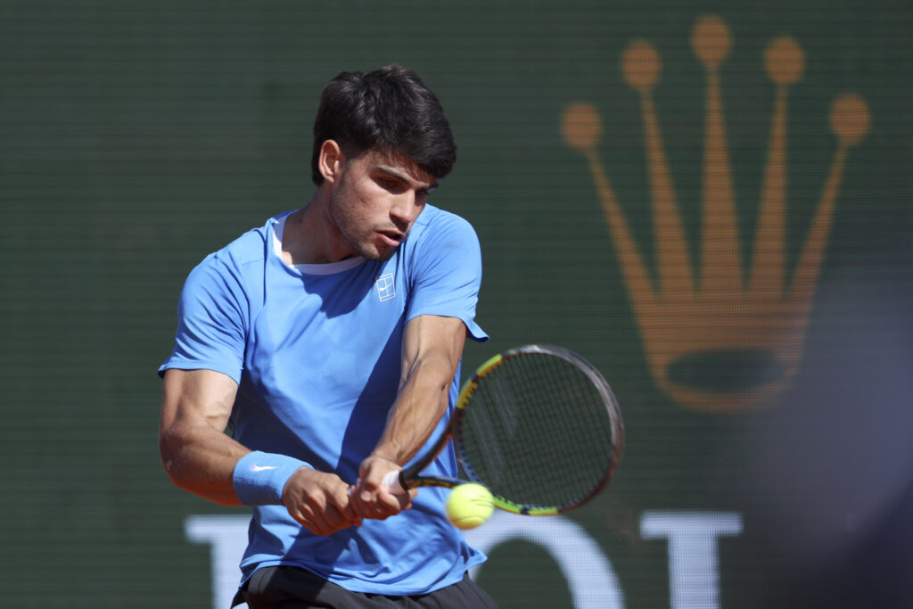 Carlos Alcaraz of Spain plays a backhand during his Round of 16 match against Tomas Etcheverry of Argentina on day Five of the Rolex Monte-Carlo Masters at Monte-Carlo Country Club on April 9, 2025 in Monte-Carlo, Monaco.