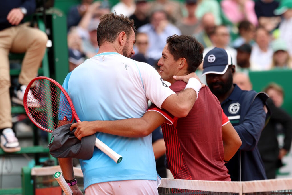 Stan Wawrinka of Switzerland and Sebastian Baez of Argentina (R) embrace at the net after their Men's Singles First Round match on day two of the Rolex Monte-Carlo Masters at Monte-Carlo Country Club on April 06, 2026 in Monte-Carlo, Monaco.
