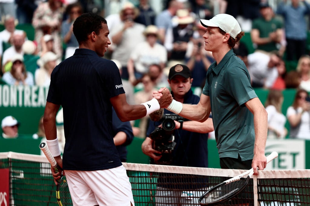 Felix Auger-Aliassime shakes Jannik Sinner's hand after their match at the 2026 Monte Carlo Masters.