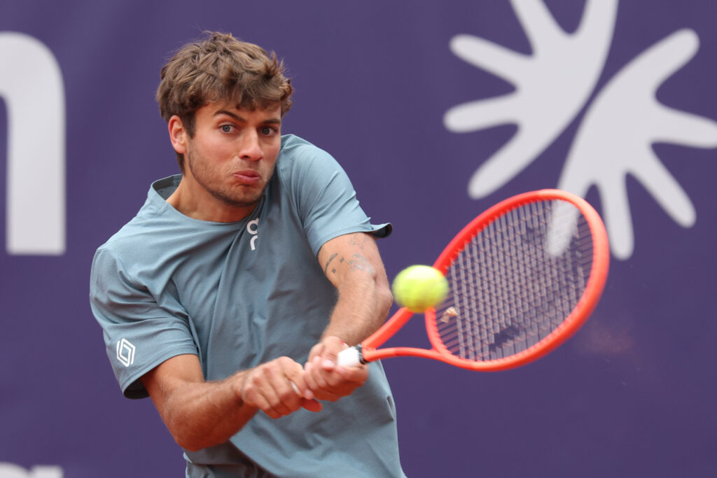 Flavio Cobolli of Italy plays a backhand against Diego Dedura of Germany during their Men's Singles match on day four of the BMW Open at MTTC IPHITOS on April 14, 2026 in Munich, Germany.