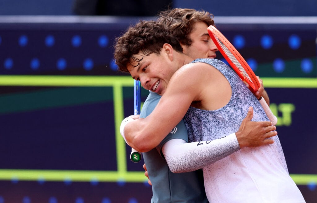 US' Ben Shelton (R) hugs Italy's Flavio Cobolli after defeating him in the men's singles final match at the ATP Munich Open tennis tournament in Munich, southern Germany on April 19, 2026.