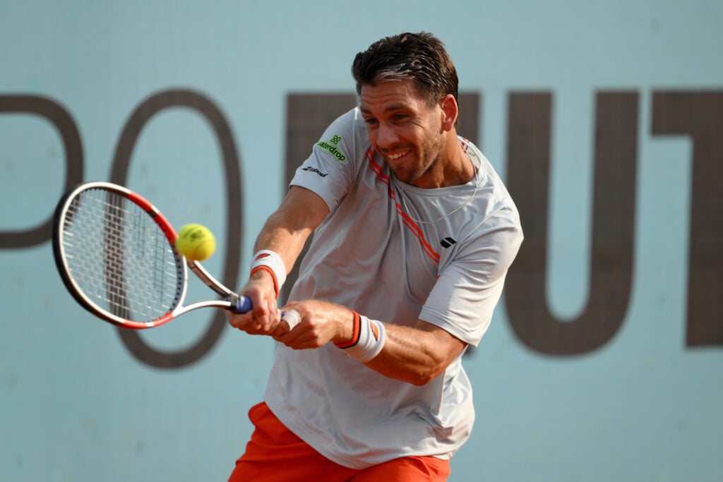 Cameron Norrie of Great Britain plays a backhand against Tomas Machac of Czechia during the Men's Singles Round of 64 match on Day Five of the Mutua Madrid Open at La Caja Magica on April 24, 2026 in Madrid, Spain.