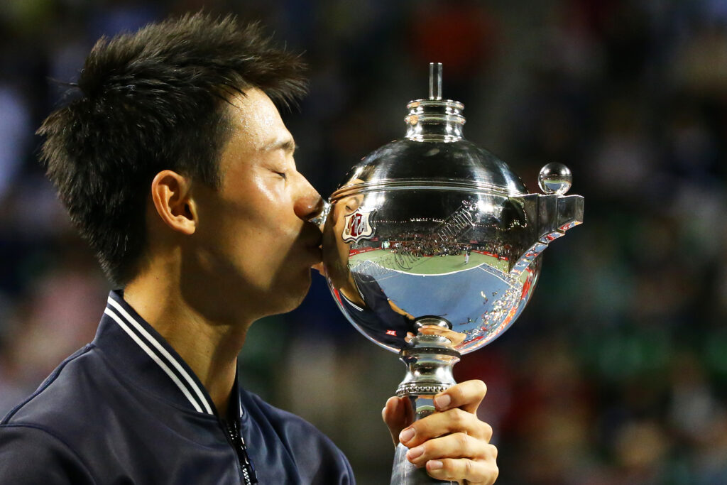 Kei Nishikori celebrates after winning the 2014 Japan Open