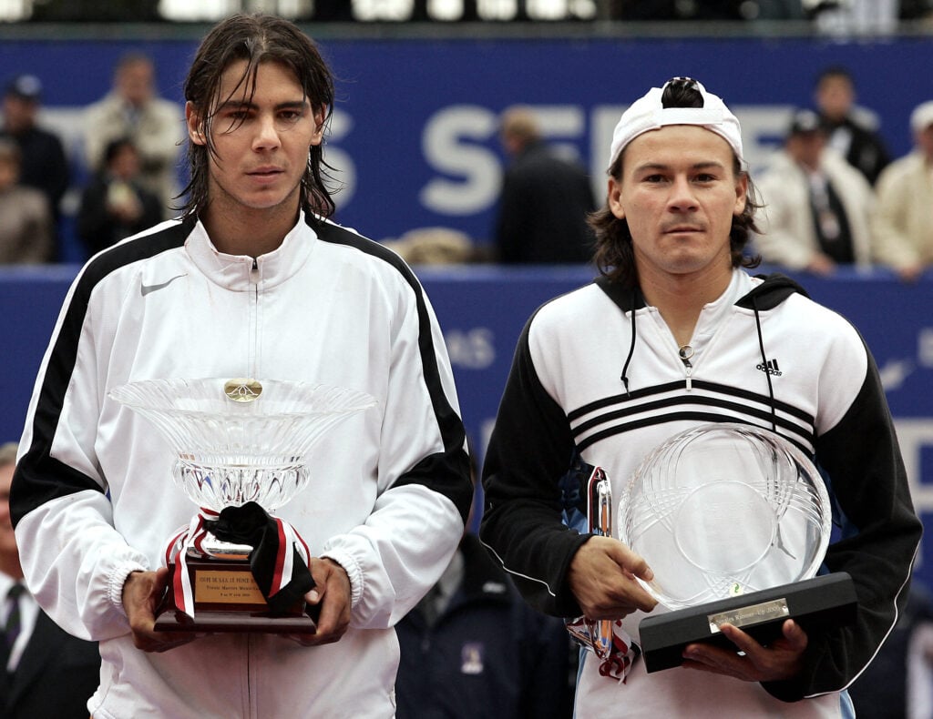 Spain's Rafael Nadal (L) poses on the podium after winning over Argentina's Guillermo Coria (R) at the end of their Tennis Masters Series final match, 17 April 2005 in Monaco. Nadal won 6-3, 6-1, 0-6, 7-5.