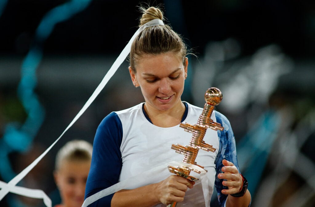 Romanian tennis player Simona Halep poses with her trophy as she celebrates her victory over French tennis player Kristina Mladenovic after the WTA Madrid Open final in Madrid, on May 13, 2017. Halep won 7-5, 6-7 and 6-2.