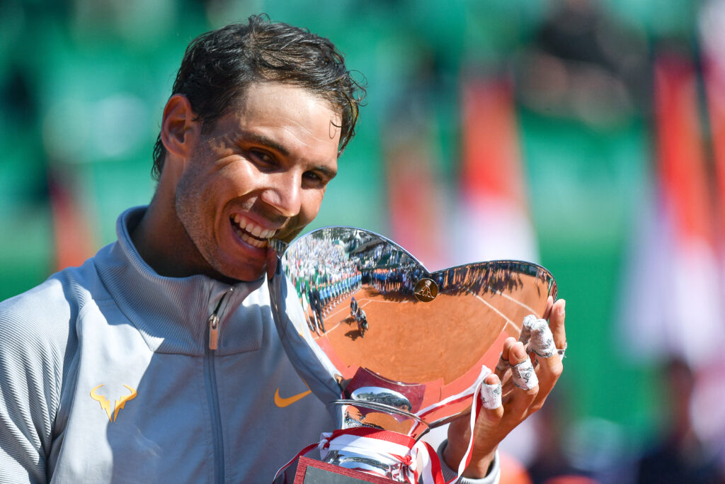 Spain's Rafael Nadal holds the trophy as he celebrates his win over Japan's Kei Nishikori in their final match at the Monte-Carlo ATP Masters Series tournament on April 22, 2018, in Monaco. Nadal, 31-years-old, saw off Nishikori 6-3, 6-2 to become the first man to win a tournament 11 times in the Open era with his 76th ATP Tour triumph. Nadal's 31st Masters title is also an outright record, pulling him out of a tie with Novak Djokovic.