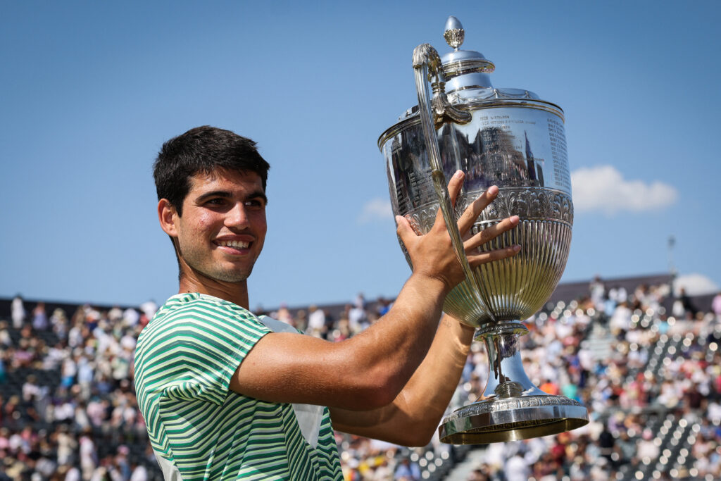 Spain's Carlos Alcaraz celebrates with the trophy after winning against Australia's Alex de Minaur at the end of their men's singles final match at the Cinch ATP tennis Championships at Queen's Club in west London on June 25, 2023.