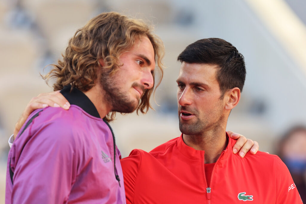 Stefanos Tsitsipas and Novak Djokovic embrace after the 2021 French Open final