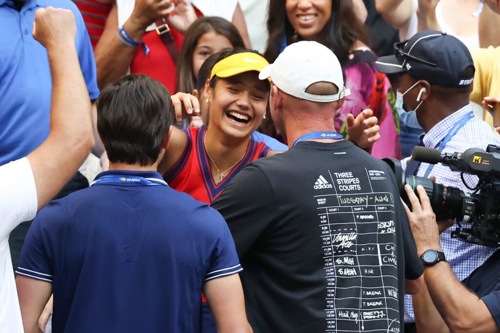 Emma Raducanu and Andrew Richardson embrace after winning the 2021 US Open